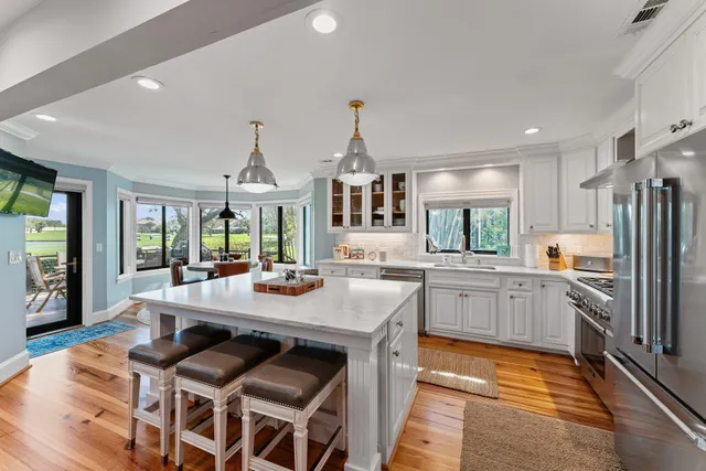a kitchen with stainless steel appliances granite countertop a refrigerator stove and sink