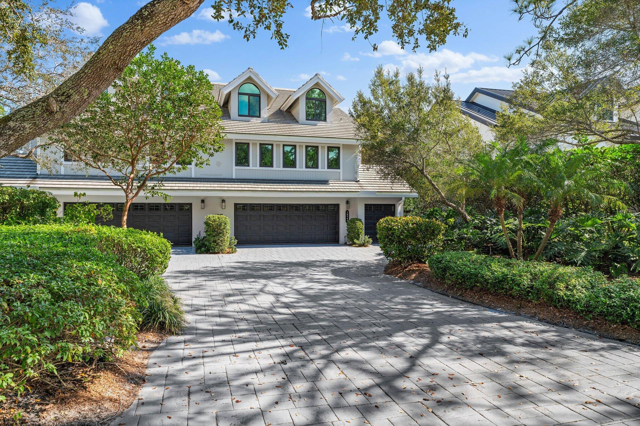 18760 Southeast Pineneedle Lane Jupiter, FL 33469 - Photo 2 of 58 a front view of a house with a garden