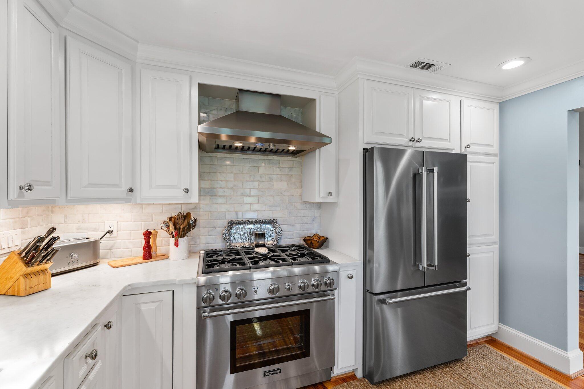 18760 Southeast Pineneedle Lane Jupiter, FL 33469 - Photo 23 of 58 a kitchen with stainless steel appliances granite countertop a refrigerator stove and sink