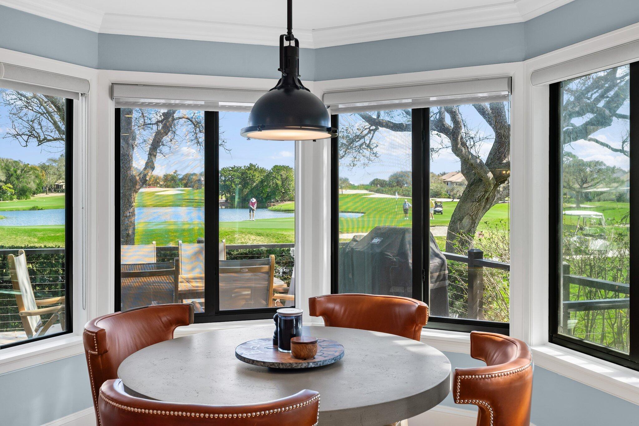 18760 Southeast Pineneedle Lane Jupiter, FL 33469 - Photo 26 of 58 a dining room with glass window and glass table