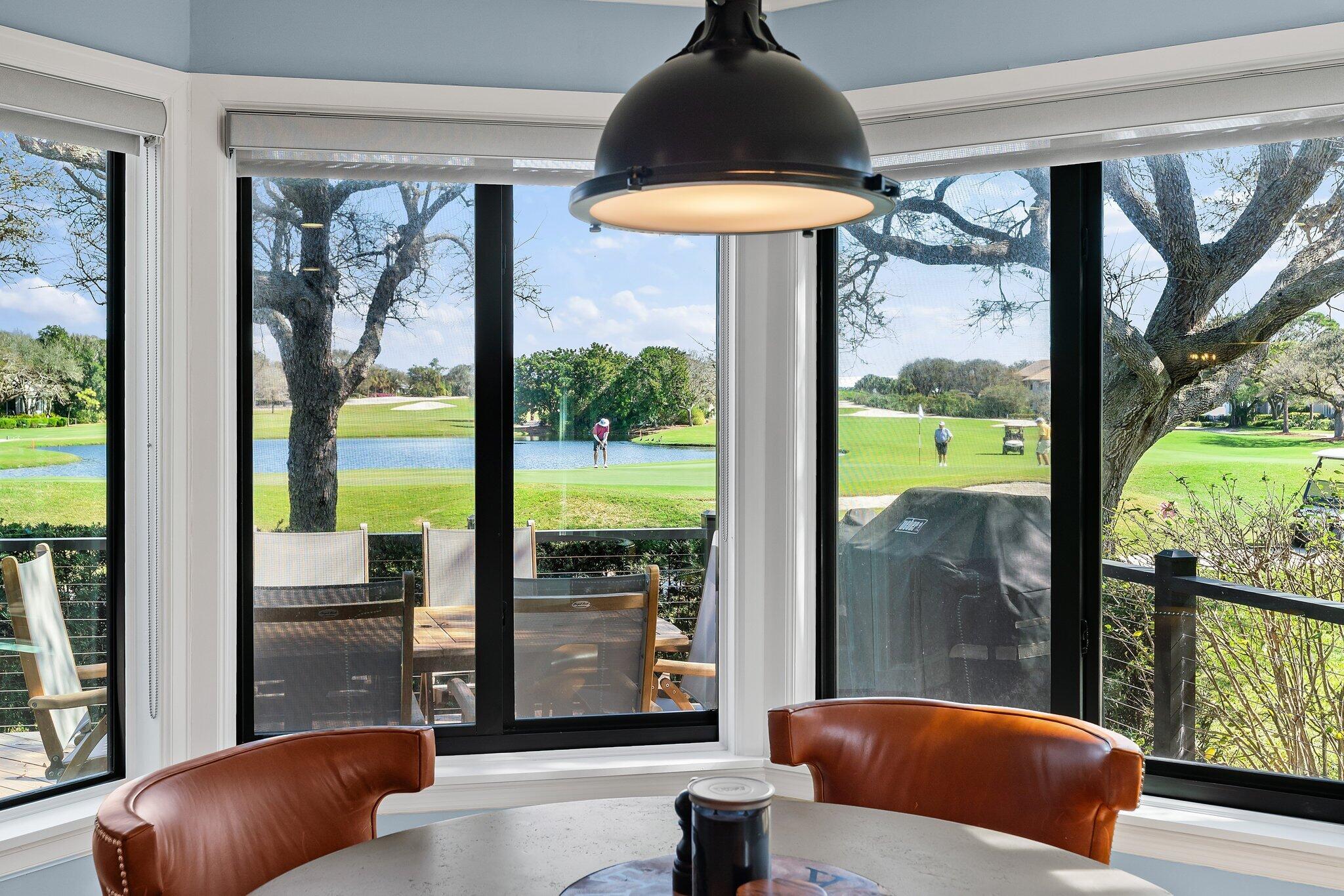 18760 Southeast Pineneedle Lane Jupiter, FL 33469 - Photo 27 of 58 a living room filled with furniture and a floor to ceiling window
