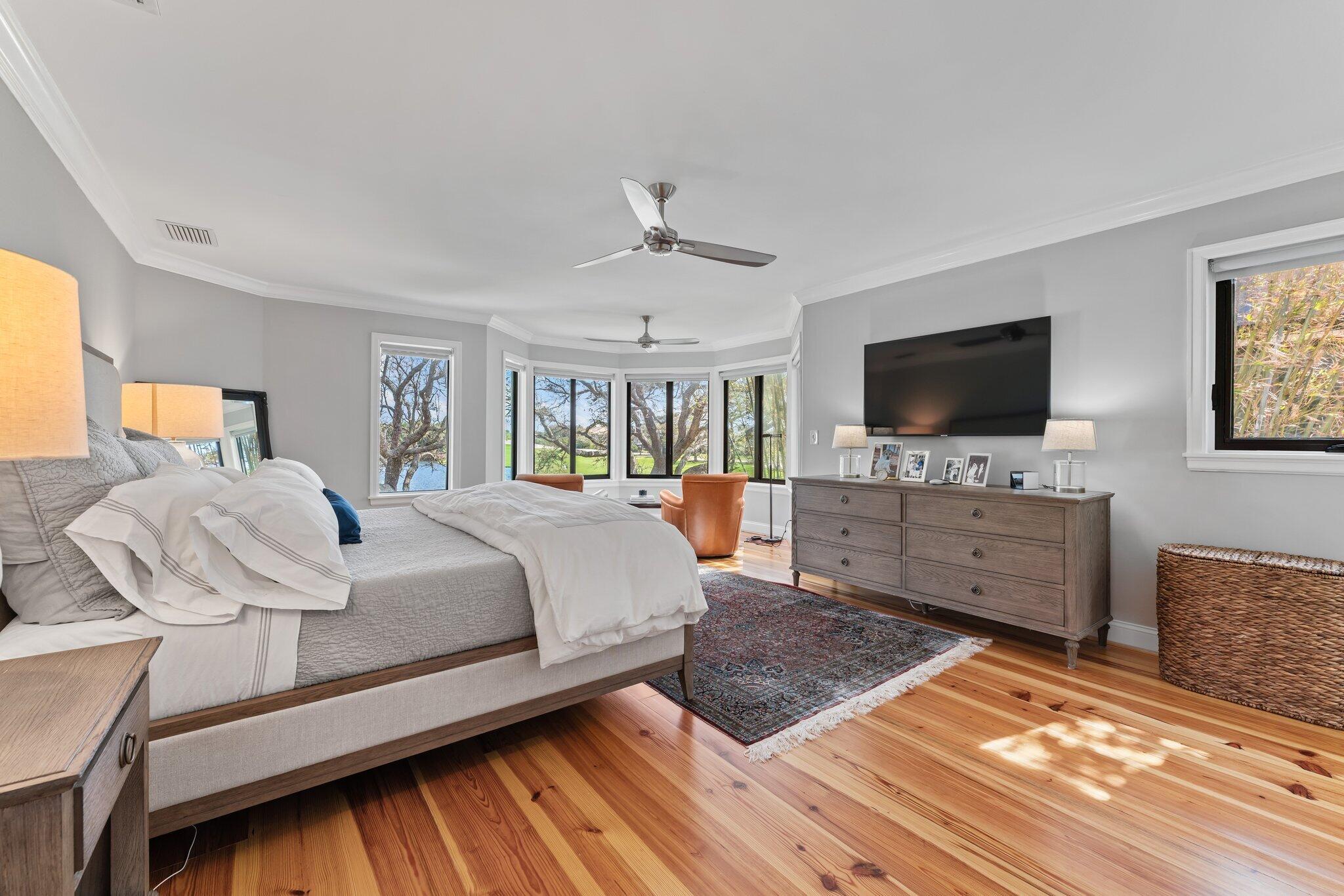 18760 Southeast Pineneedle Lane Jupiter, FL 33469 - Photo 29 of 58 a spacious bedroom with a bed and a flat screen tv