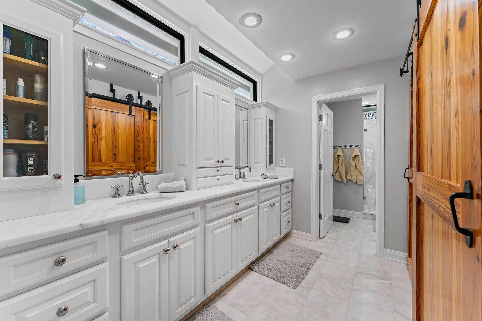 18760 Southeast Pineneedle Lane Jupiter, FL 33469 - Photo 33 of 58 a spacious bathroom with a double vanity sink double mirror and a shower