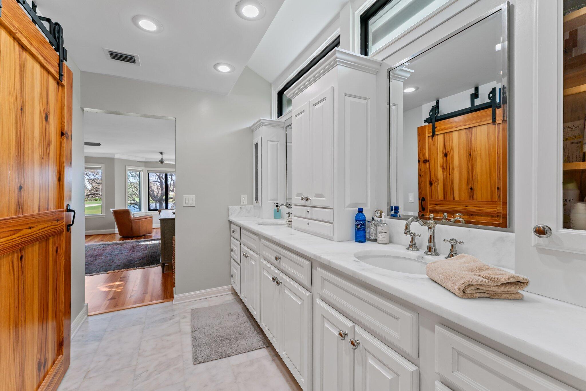 18760 Southeast Pineneedle Lane Jupiter, FL 33469 - Photo 34 of 58 a bathroom with double vanity and a mirror