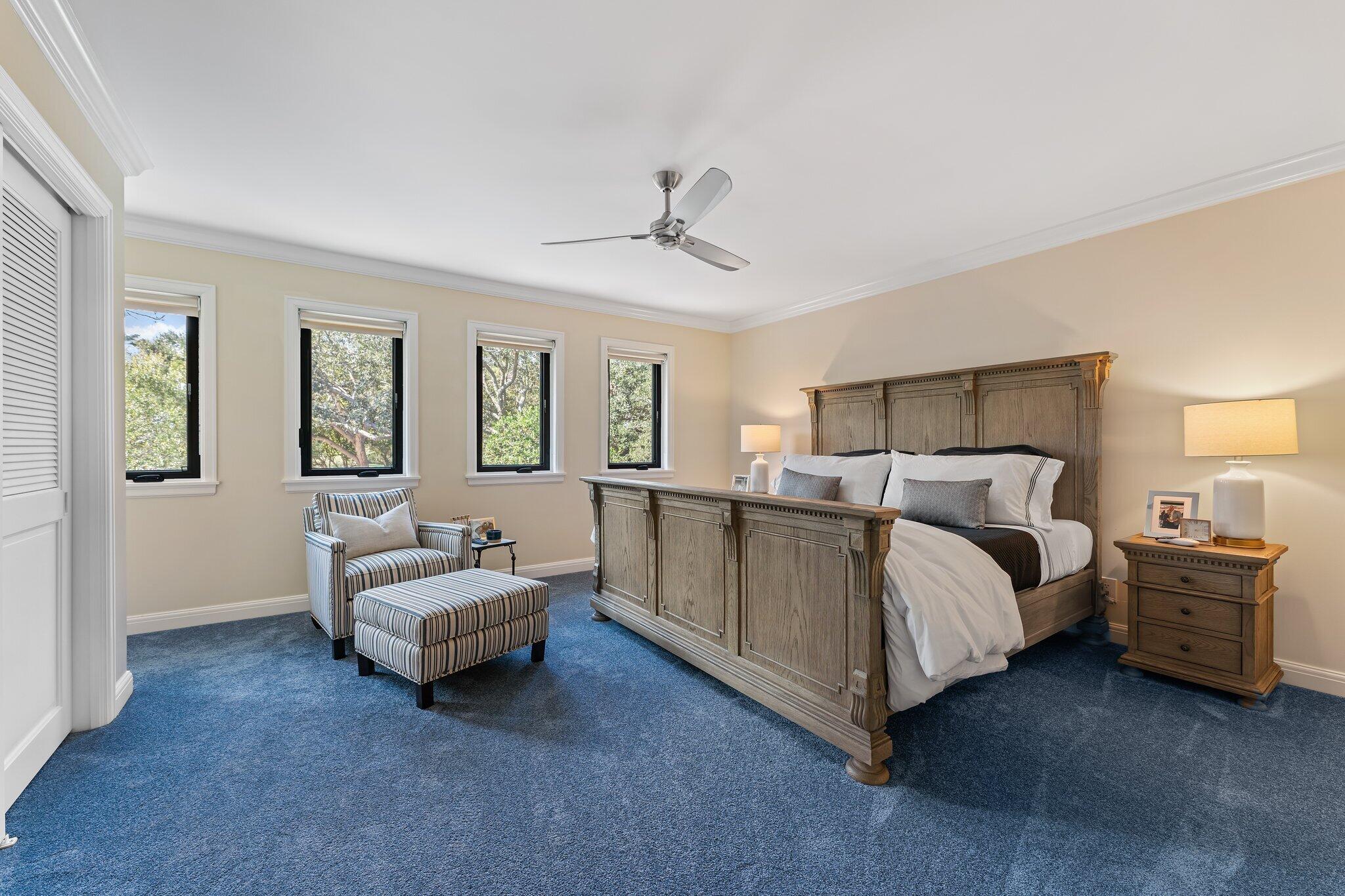 18760 Southeast Pineneedle Lane Jupiter, FL 33469 - Photo 36 of 58 a spacious bedroom with a bed and a chandelier