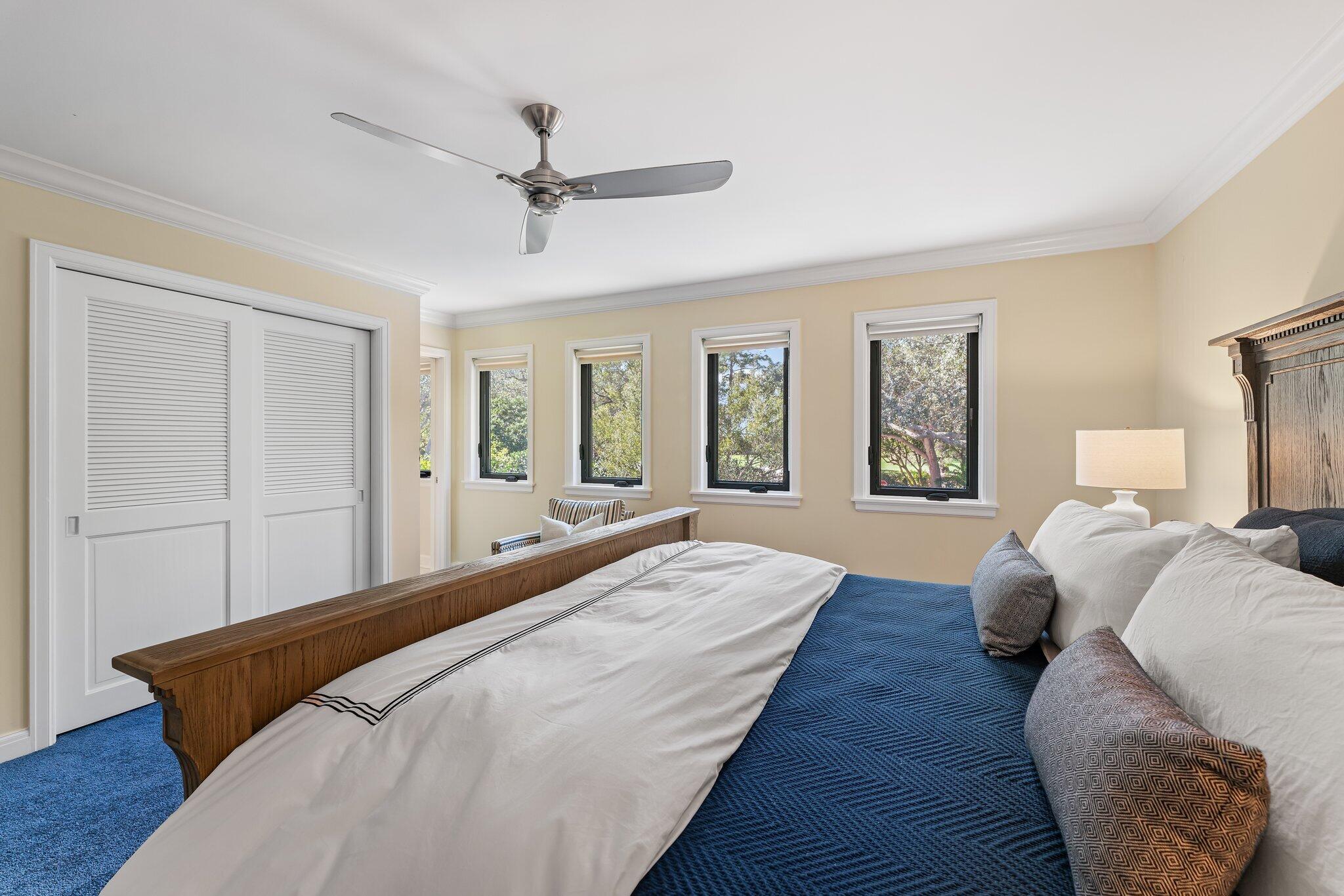 18760 Southeast Pineneedle Lane Jupiter, FL 33469 - Photo 37 of 58 a spacious bedroom with a bed and wooden floor