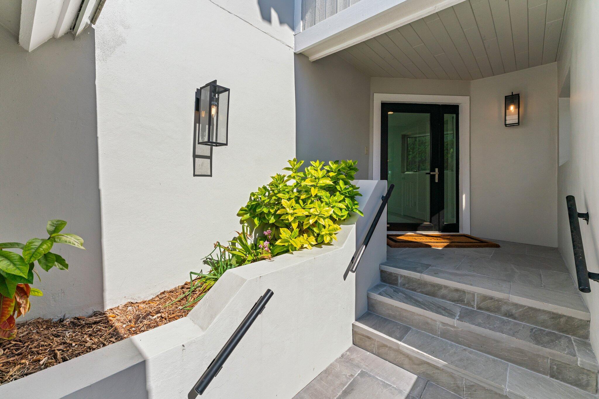 18760 Southeast Pineneedle Lane Jupiter, FL 33469 - Photo 4 of 58 a wooden bench sitting in front of a door
