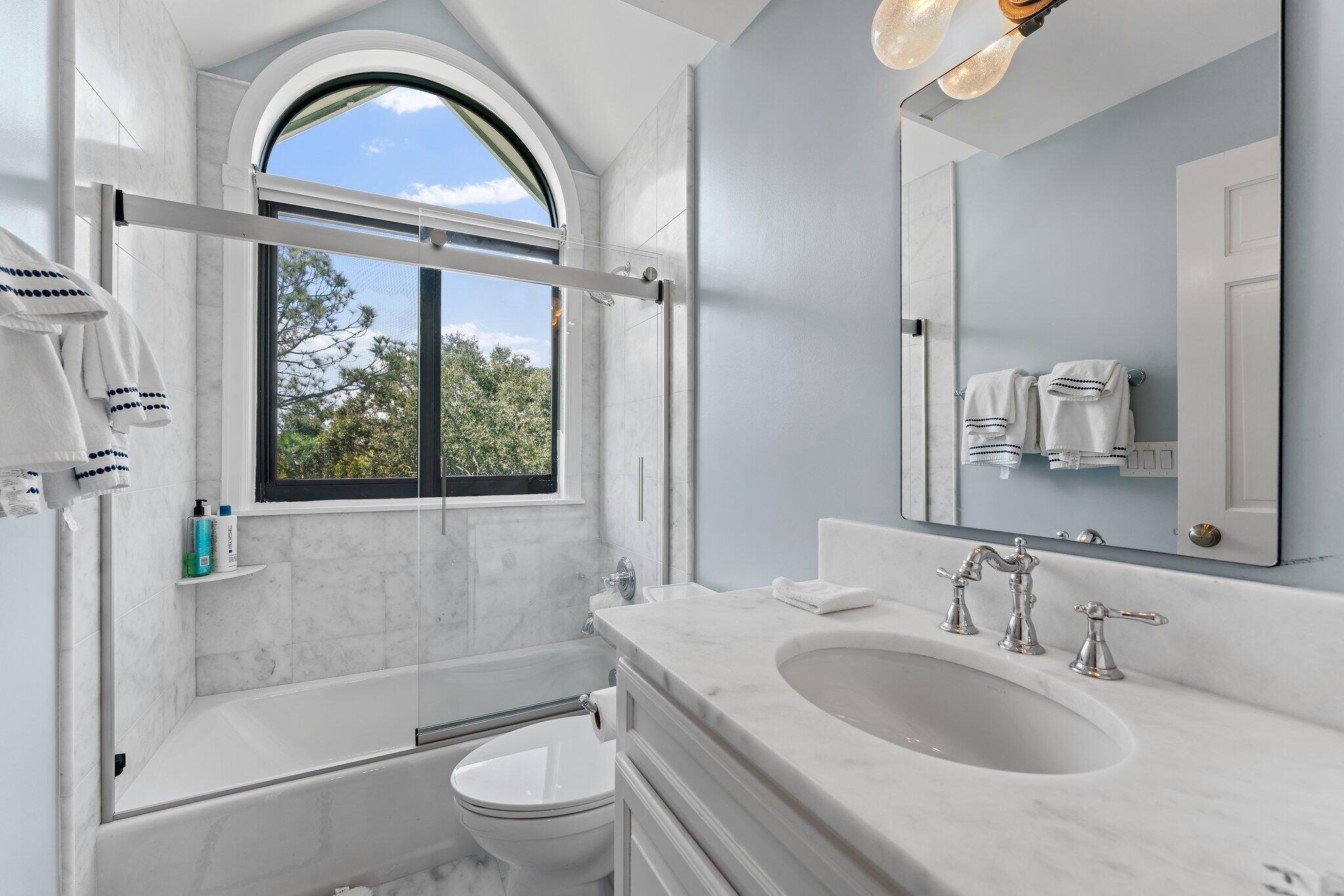 18760 Southeast Pineneedle Lane Jupiter, FL 33469 - Photo 42 of 58 a bathroom with a sink a toilet and a mirror