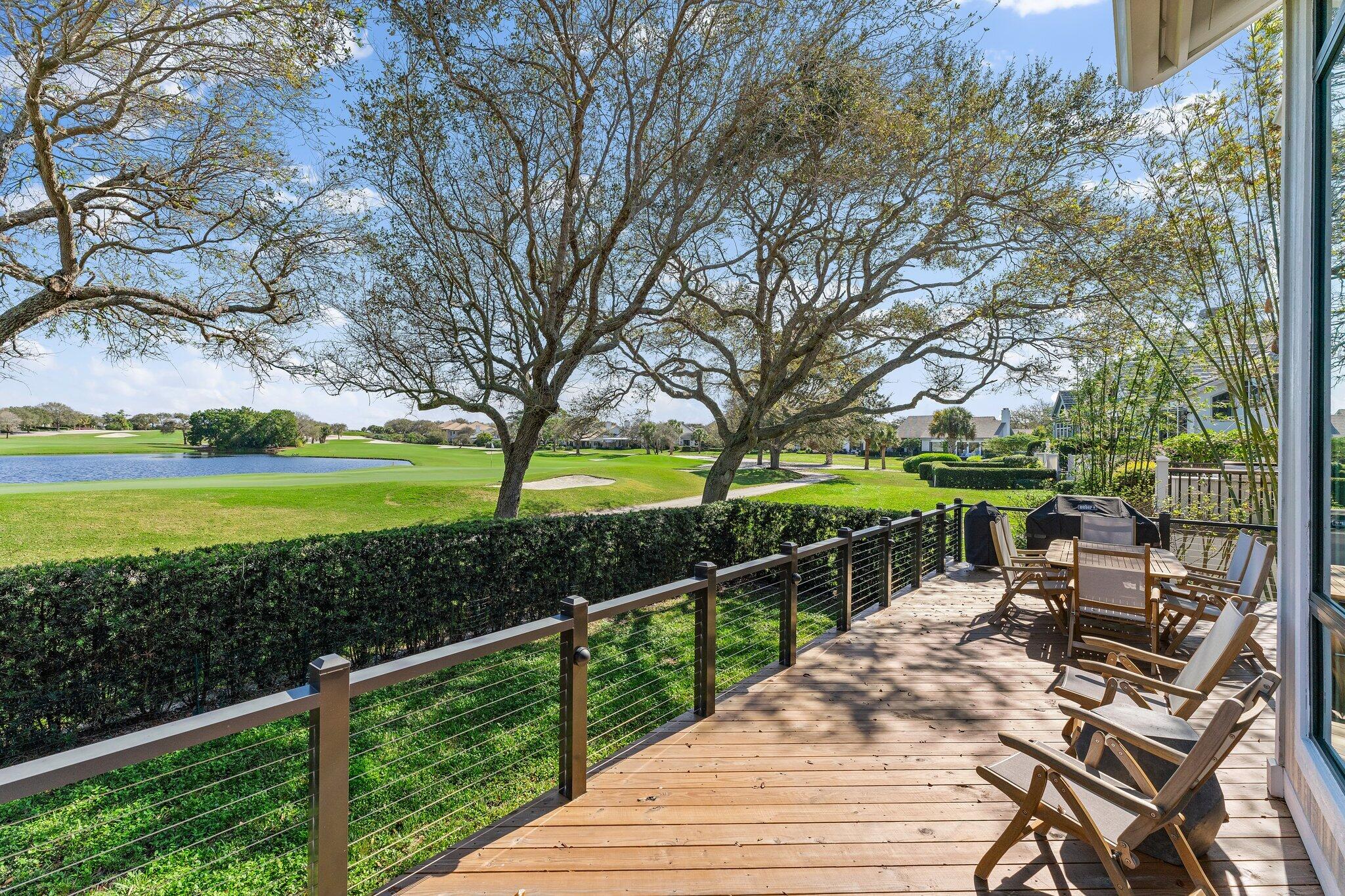 18760 Southeast Pineneedle Lane Jupiter, FL 33469 - Photo 44 of 58 a view of a wooden deck and a garden