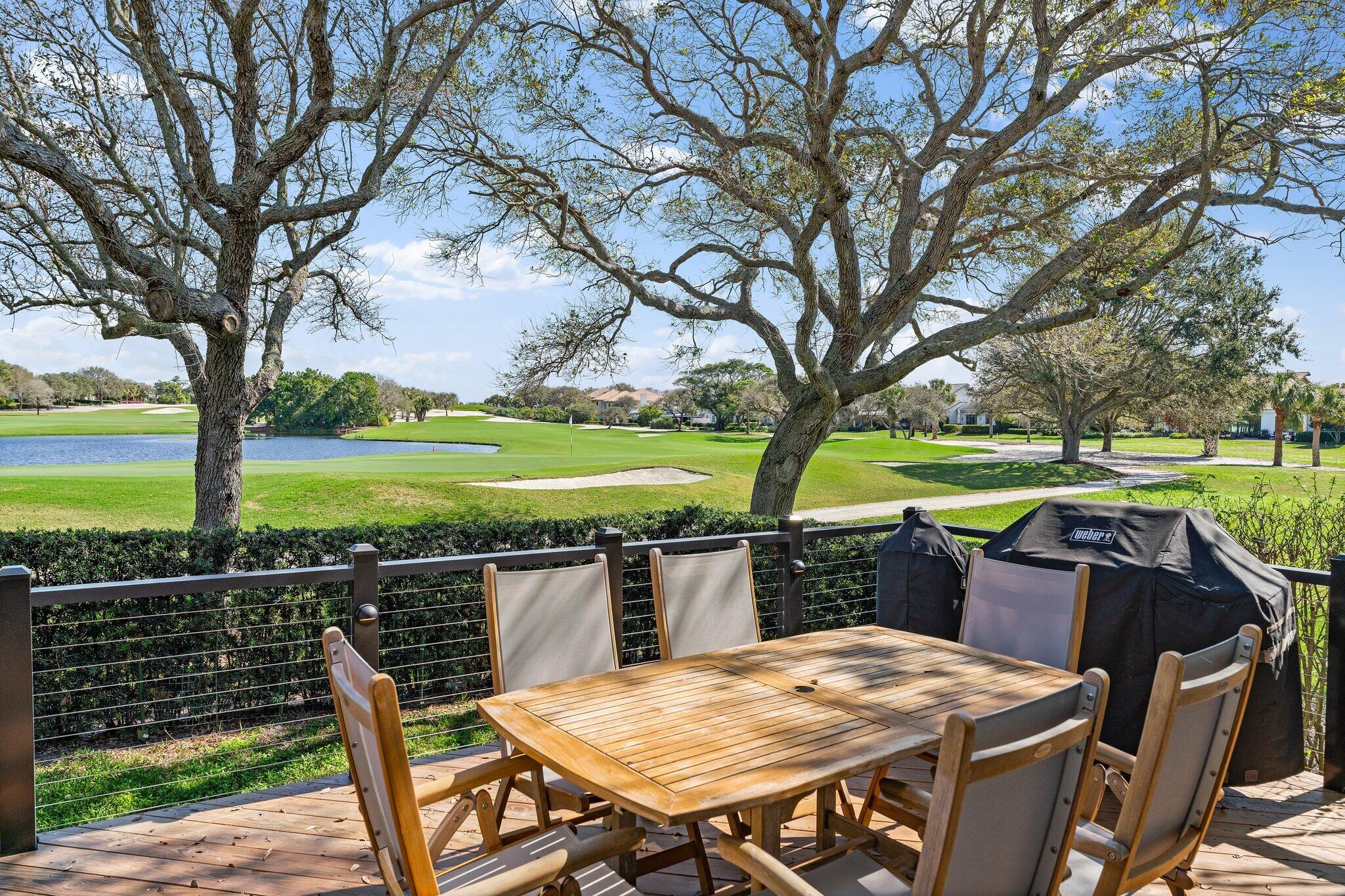 18760 Southeast Pineneedle Lane Jupiter, FL 33469 - Photo 46 of 58 a view of a chairs and table on the deck and a backyard