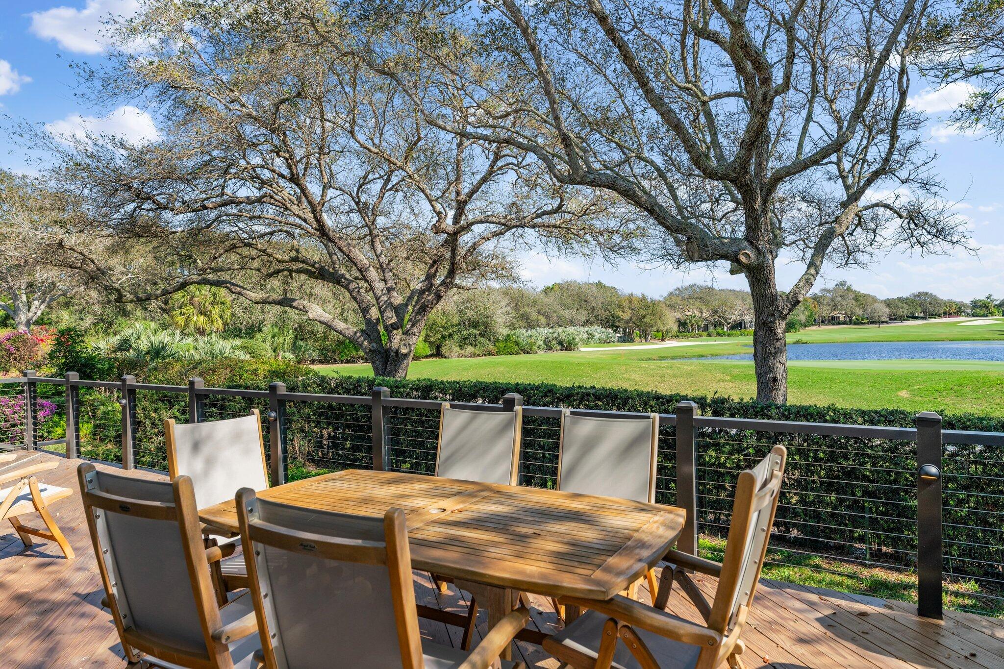 18760 Southeast Pineneedle Lane Jupiter, FL 33469 - Photo 47 of 58 a view of a deck with a table chairs and a barbeque