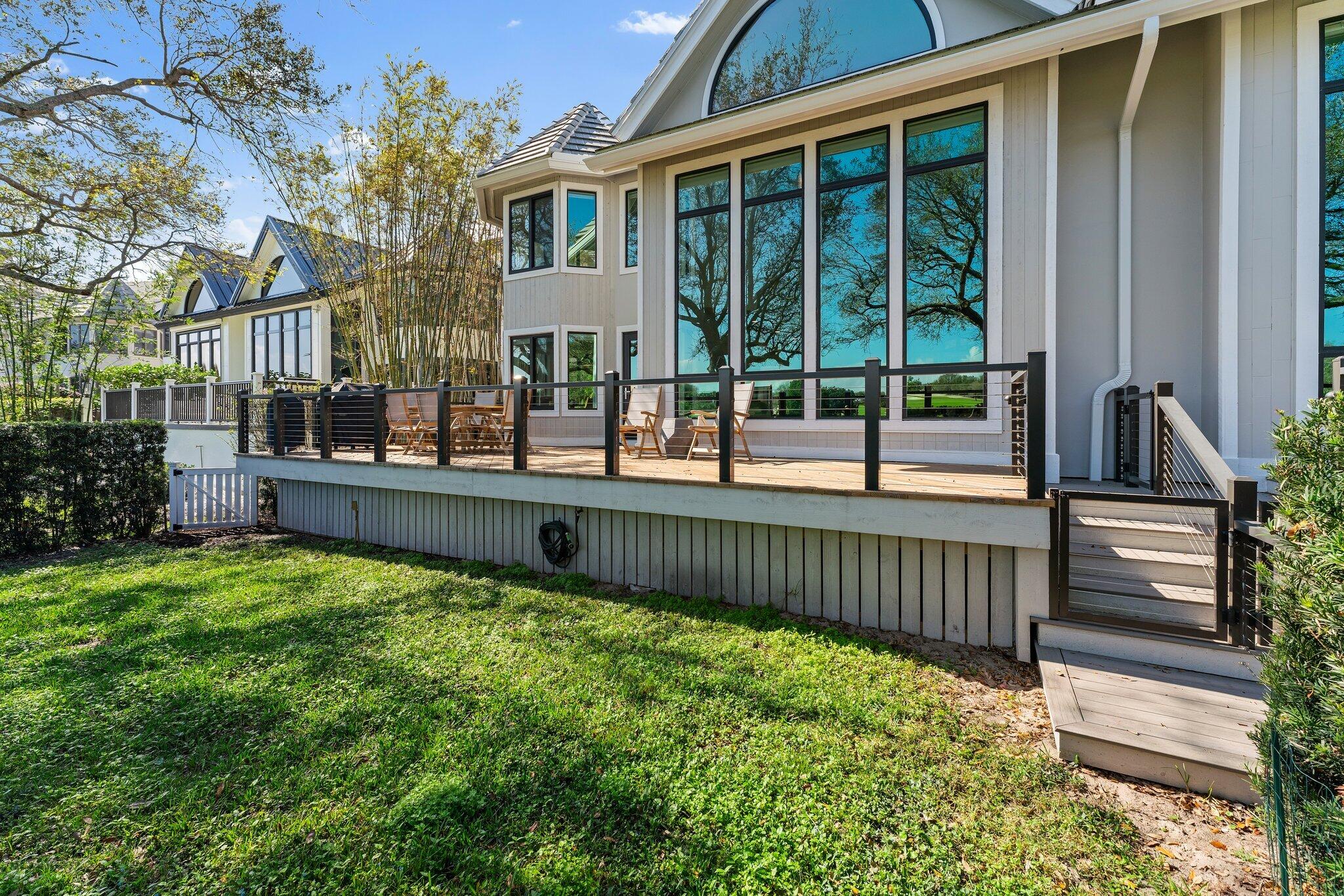 18760 Southeast Pineneedle Lane Jupiter, FL 33469 - Photo 50 of 58 a view of a house with a small yard and wooden fence