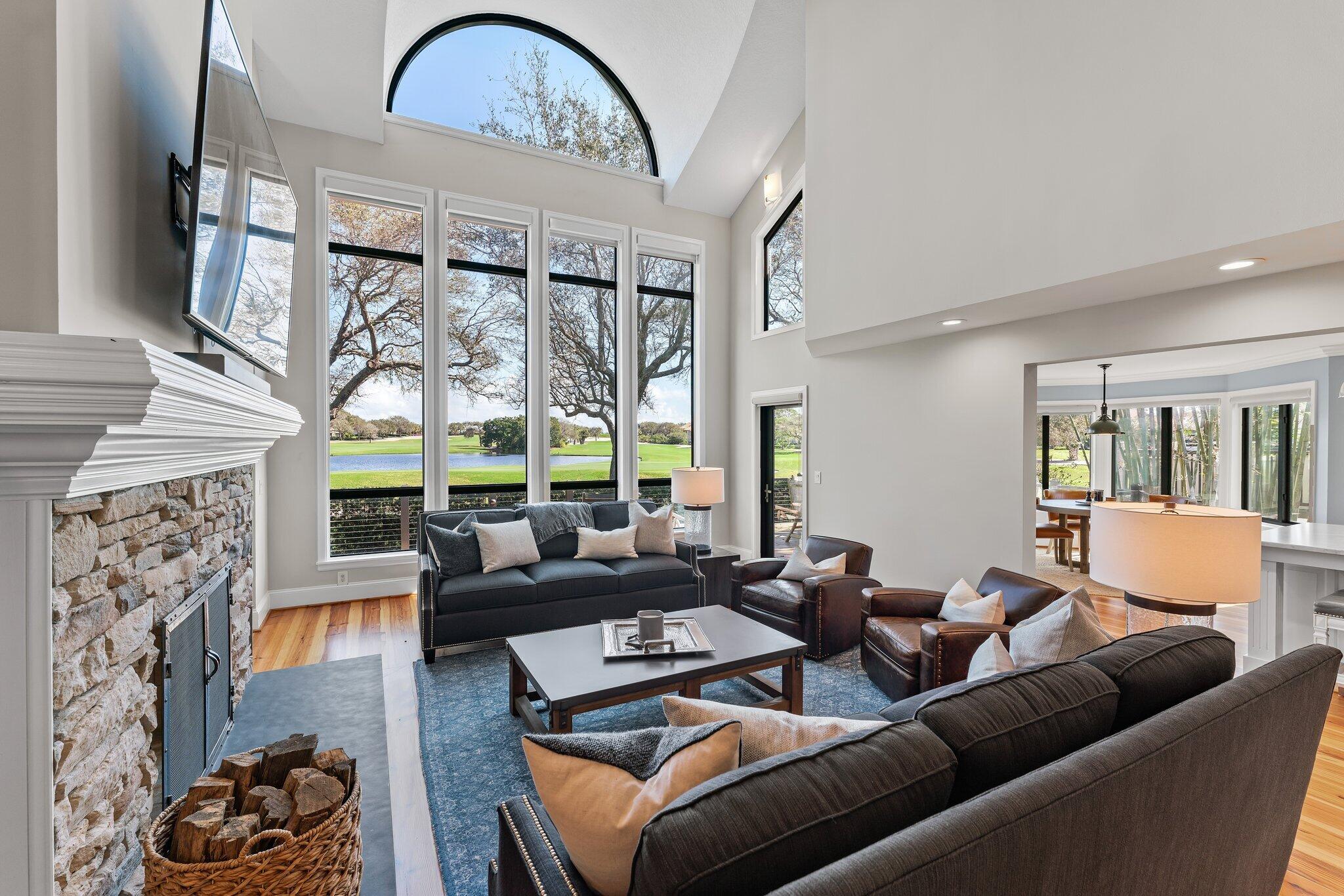 18760 Southeast Pineneedle Lane Jupiter, FL 33469 - Photo 7 of 58 a living room with furniture a large window and a fireplace