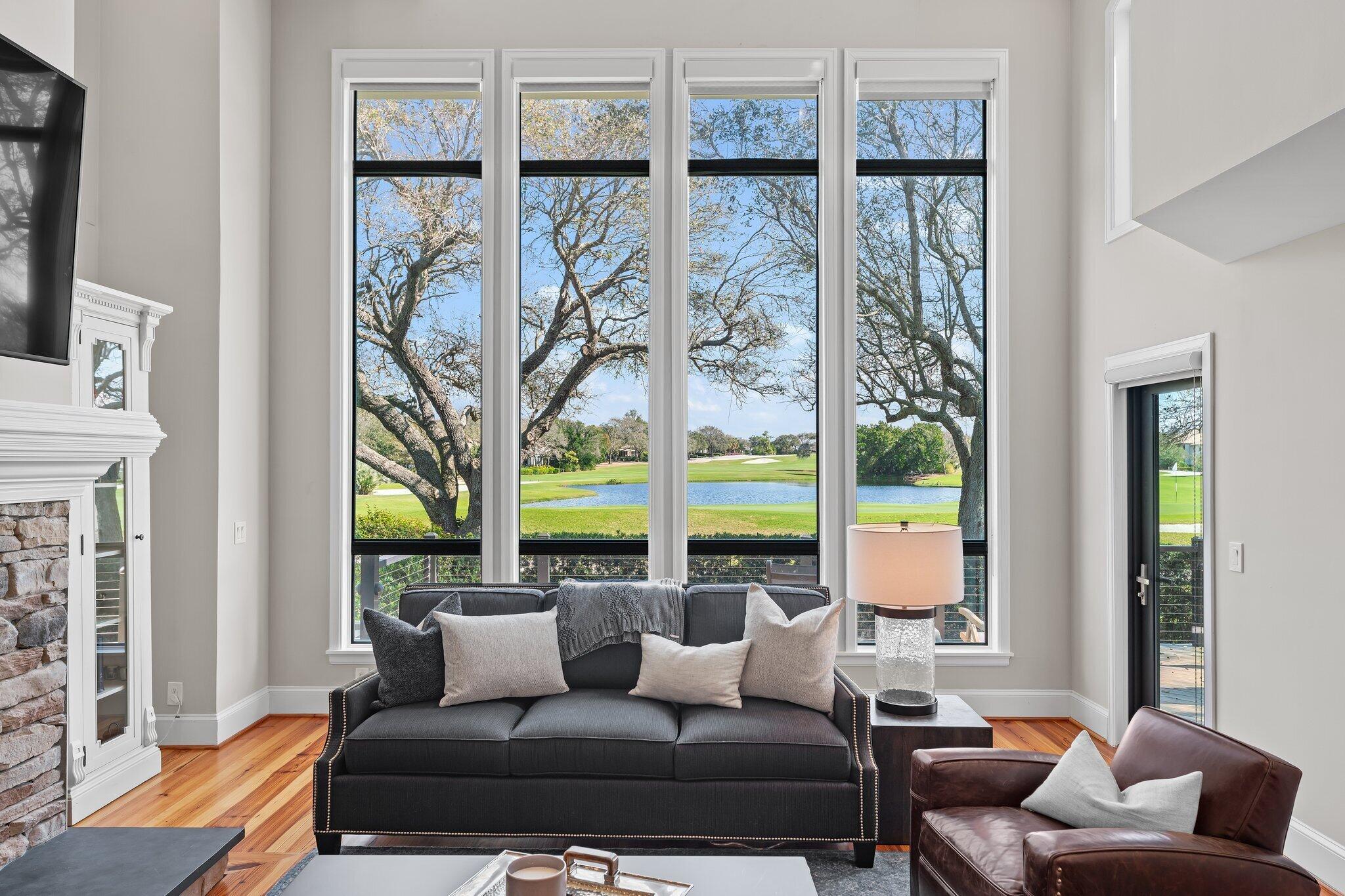 18760 Southeast Pineneedle Lane Jupiter, FL 33469 - Photo 8 of 58 a living room with furniture and a floor to ceiling window