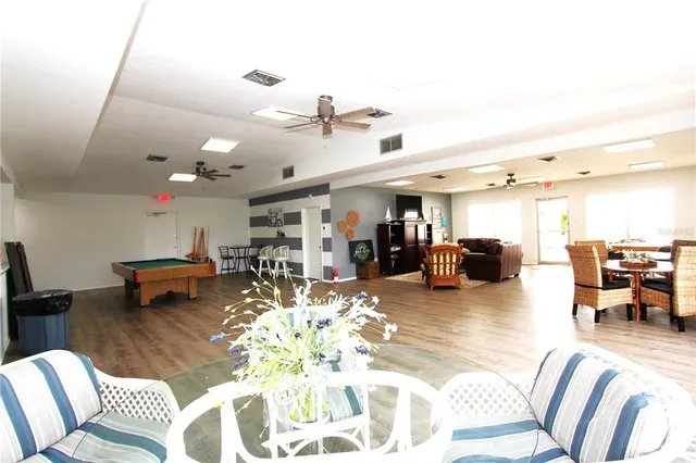 a living room with furniture and kitchen view