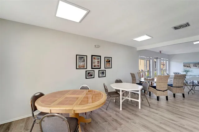 a view of a room with furniture and wooden floor