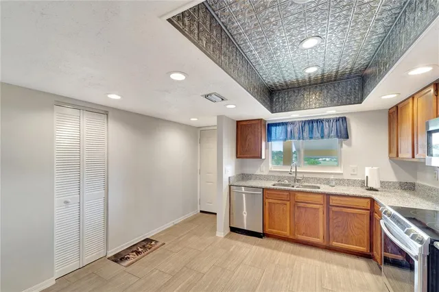 a kitchen with stainless steel appliances granite countertop a sink and cabinets