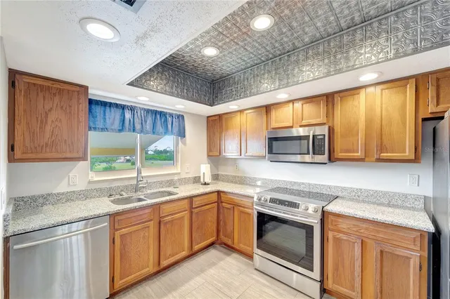 a kitchen with a sink window and cabinets