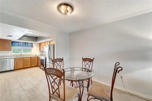 a view of a dining room with furniture and a kitchen