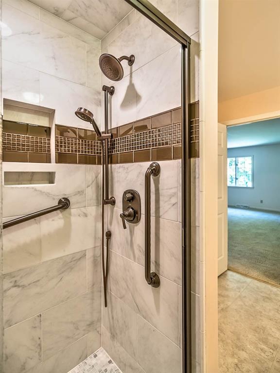 558 Callery Road Cranberry Township, PA 16066 - Photo 13 of 25 The Spa-like Shower with Bronze fixtures in the Master Bedroom has a Rain Shower Head and a Hand-held Shower head.