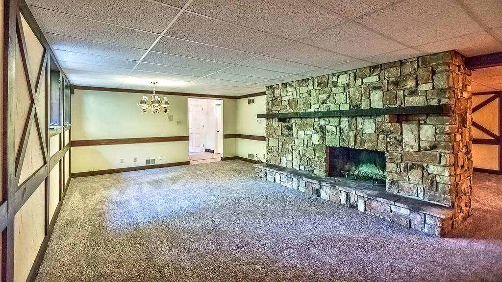 558 Callery Road Cranberry Township, PA 16066 - Photo 21 of 25 In addition to the Bar and Pool Table Area, a Large Great Room in the Lower Level Features a Stone wood-burning Fireplace. A Powder Room is also located in the Lower Level.