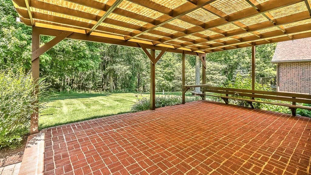 558 Callery Road Cranberry Township, PA 16066 - Photo 22 of 25 The Covered Brick Patio is a great space for Entertaining, or just relaxing and taking in the wooded Views.