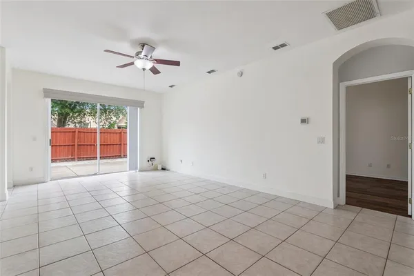 a view of a livingroom with a ceiling fan and window