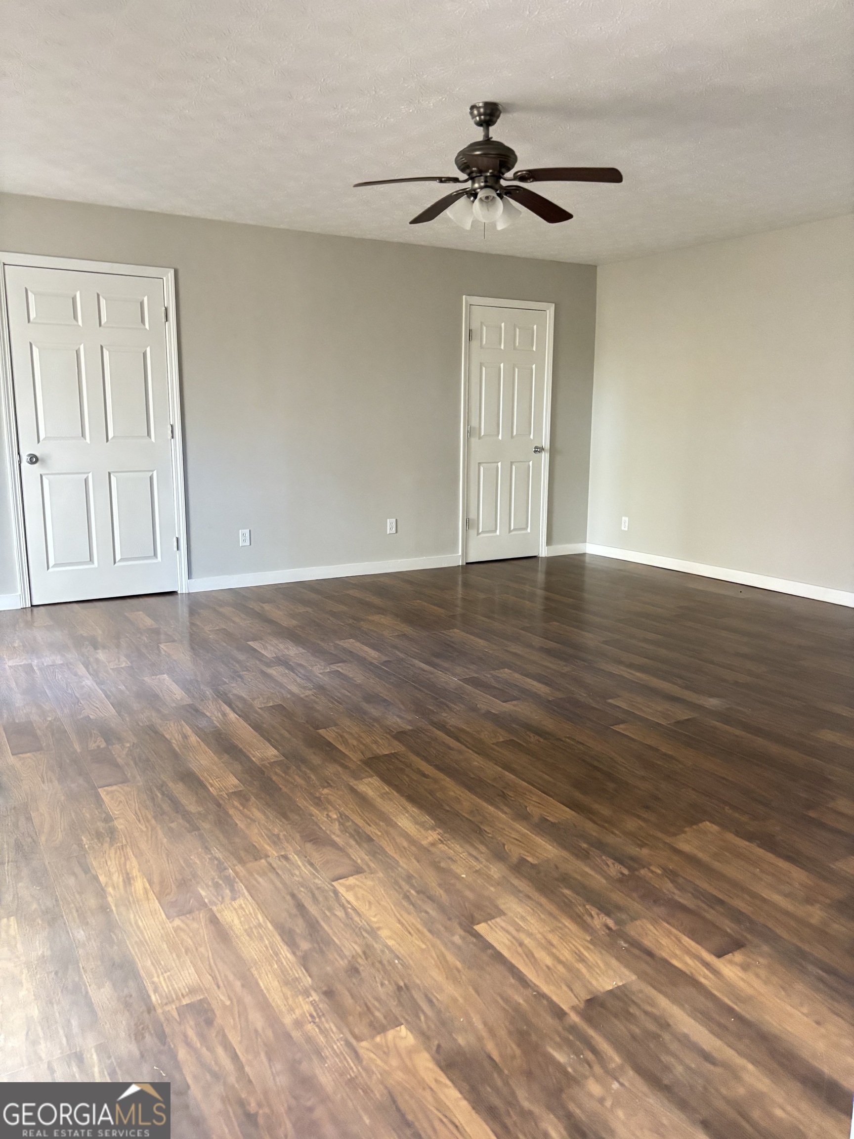 358 Whippoorwill Road Monticello, GA 31064 - Photo 19 of 20 a view of an empty room with window and wooden floor