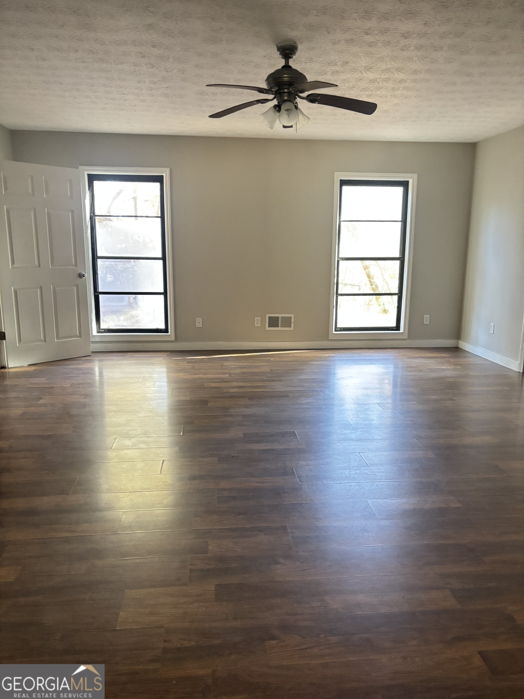 358 Whippoorwill Road Monticello, GA 31064 - Photo 20 of 20 a view of an empty room with a window and wooden floor