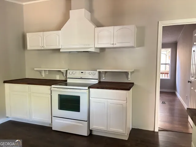 a kitchen with white cabinets and white appliances