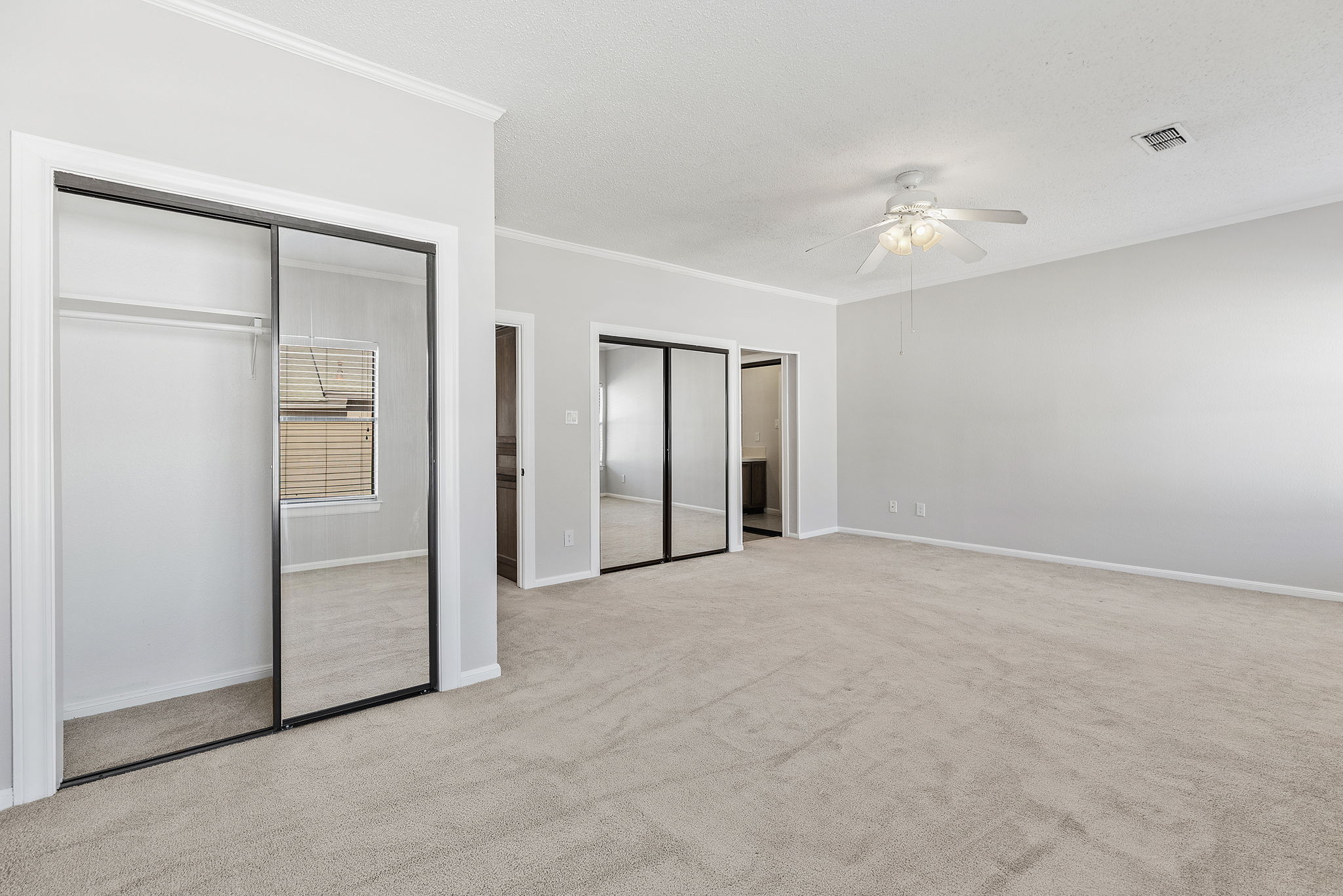10819 Crown Colony Drive, Unit 11 Austin, TX 78747 - Photo 20 of 40 Soft natural light filters in through multiple windows, creating an easy, restful atmosphere whether it’s early morning or late afternoon.