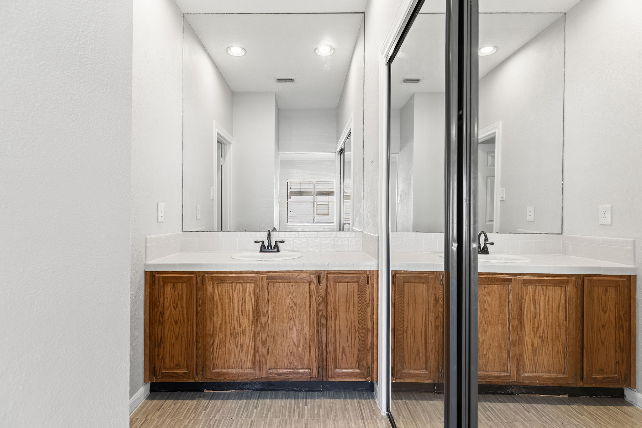 10819 Crown Colony Drive, Unit 11 Austin, TX 78747 - Photo 23 of 40 Just off the bedroom, the en-suite bath continues that sense of ease and functionality.