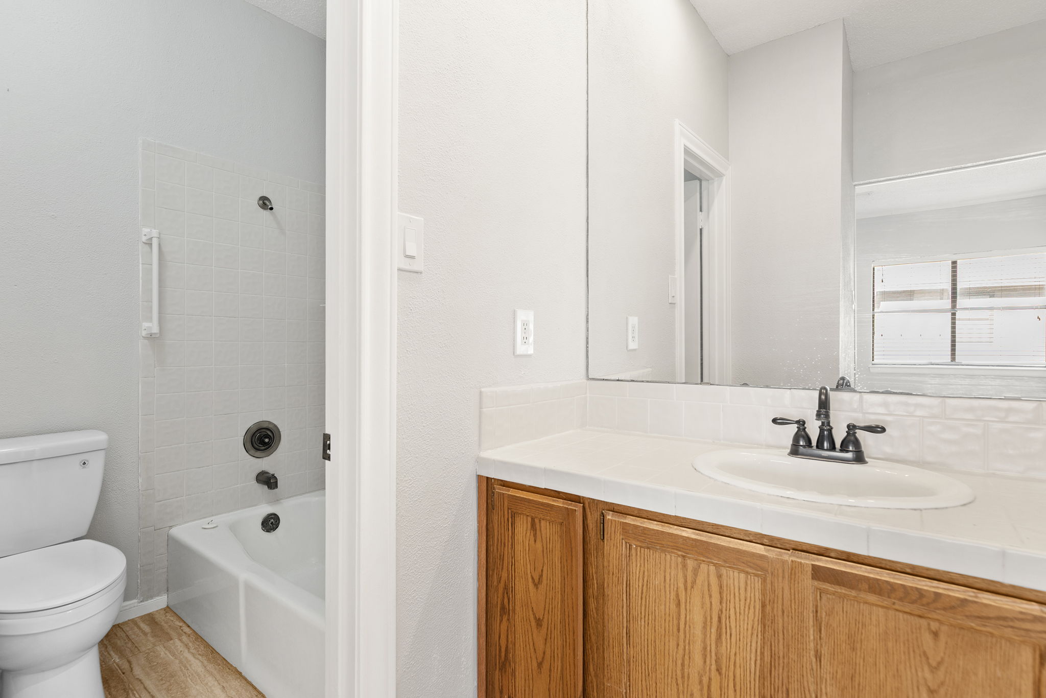 10819 Crown Colony Drive, Unit 11 Austin, TX 78747 - Photo 24 of 40 Clean tile work, a full tub and shower combination, and a calm, neutral palette create a space that feels easy to maintain and easy to personalize.
