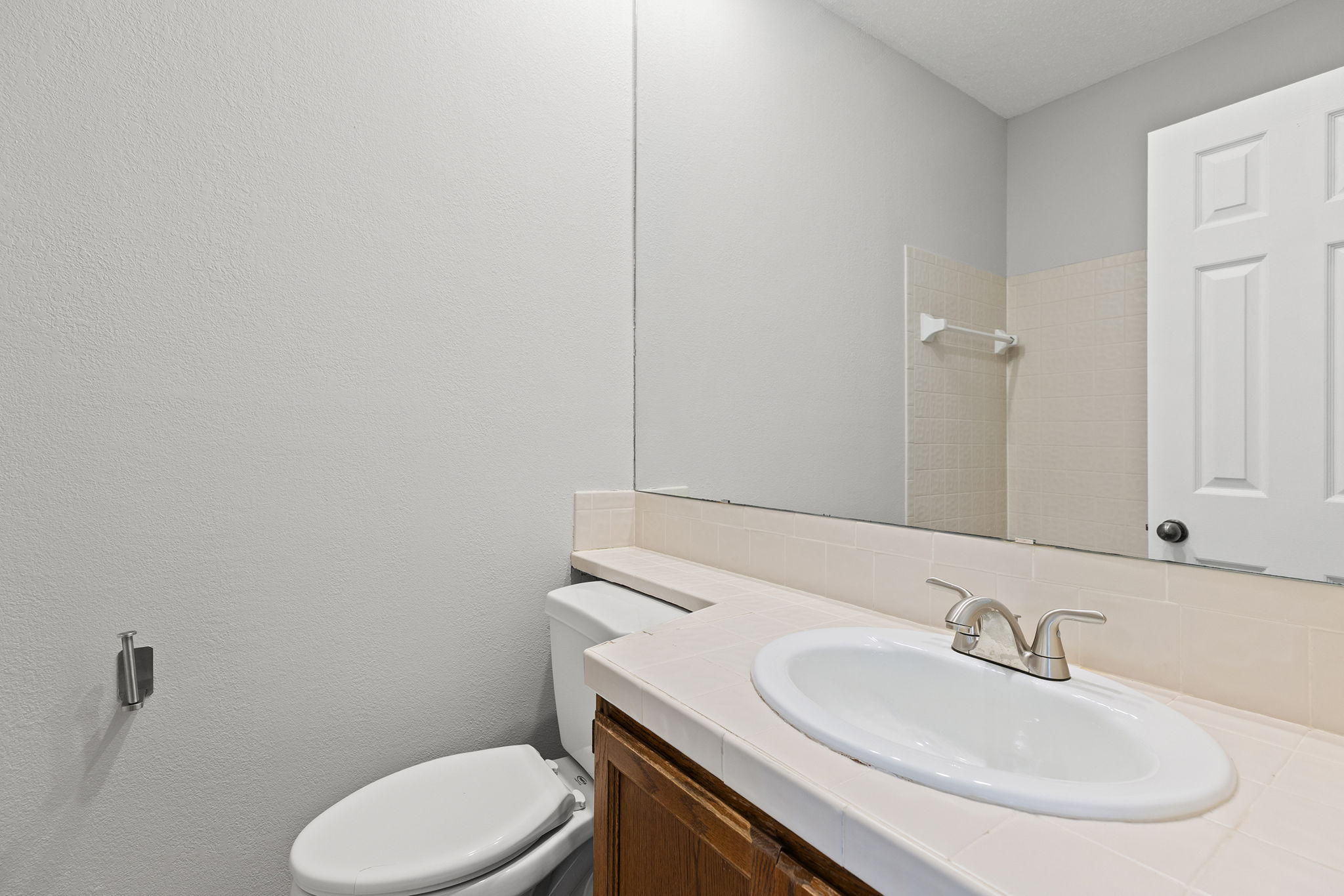 10819 Crown Colony Drive, Unit 11 Austin, TX 78747 - Photo 28 of 40 Just outside the bedroom, the full bath is thoughtfully placed for both guests and daily living.
