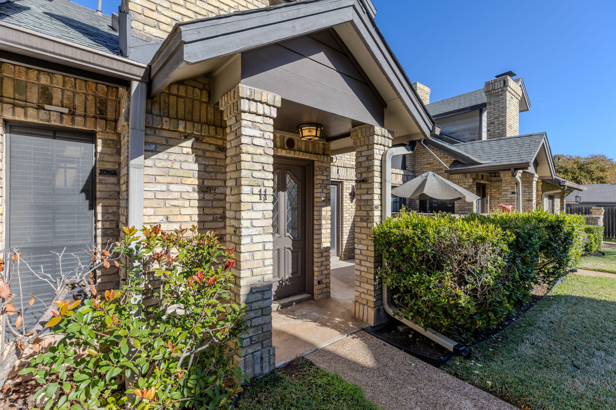 10819 Crown Colony Drive, Unit 11 Austin, TX 78747 - Photo 5 of 40 The first thing you notice is the solid feel of the home. Brick wraps the exterior, grounding the residence with a sense of permanence and quiet durability that’s hard to find in newer builds.