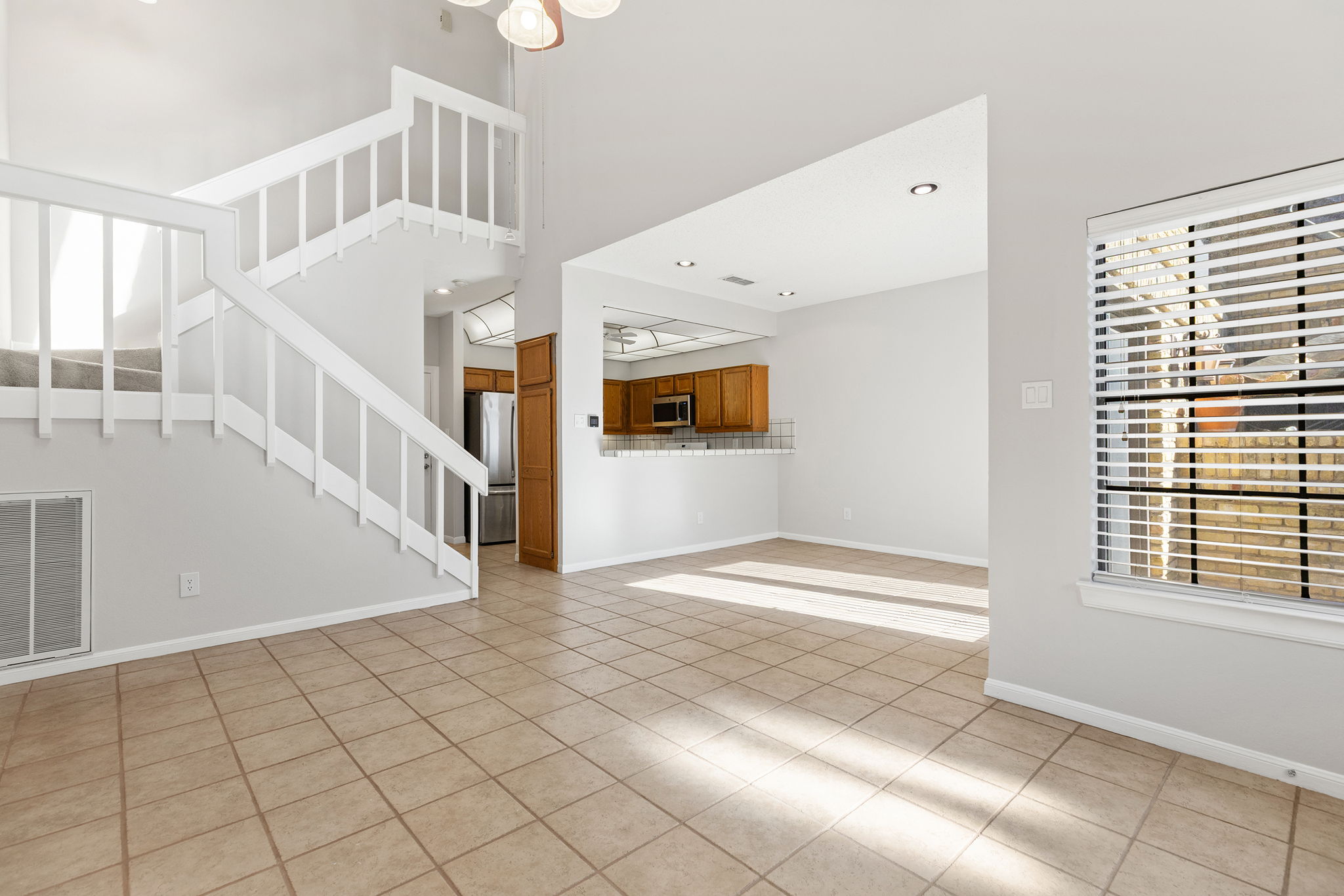 10819 Crown Colony Drive, Unit 11 Austin, TX 78747 - Photo 10 of 40 Natural light pours in through the windows, bouncing off the light-toned floors and walls, making the room feel open yet grounded.