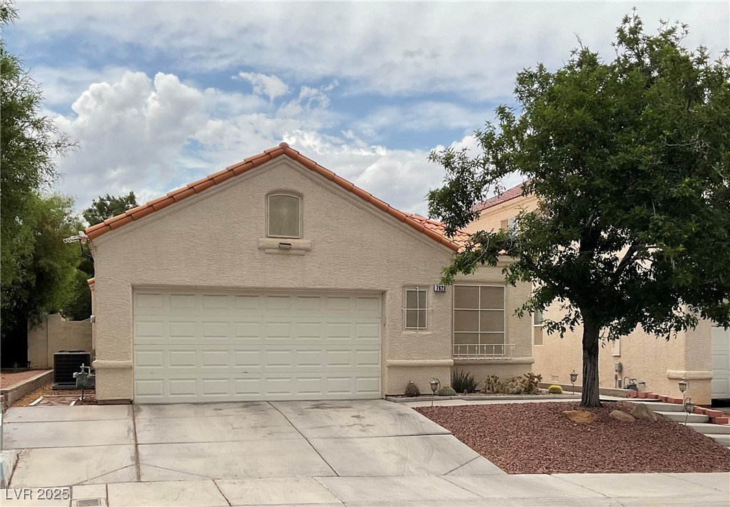 7620 Donald Nelson Avenue Las Vegas, NV 89131 - Photo 1 of 34 Mediterranean / spanish house featuring stucco siding, cooling unit, driveway, a garage, and a tile roof