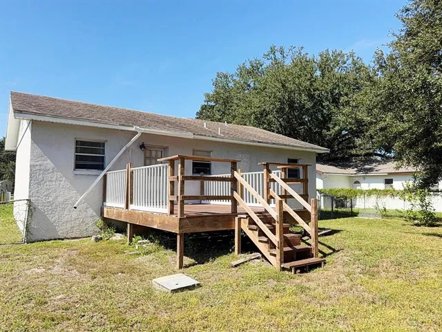 a view of a house with a yard and trees