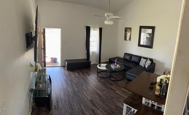 a living room with furniture and a wooden floor