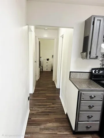 a view of a hallway with wooden floor and entryway