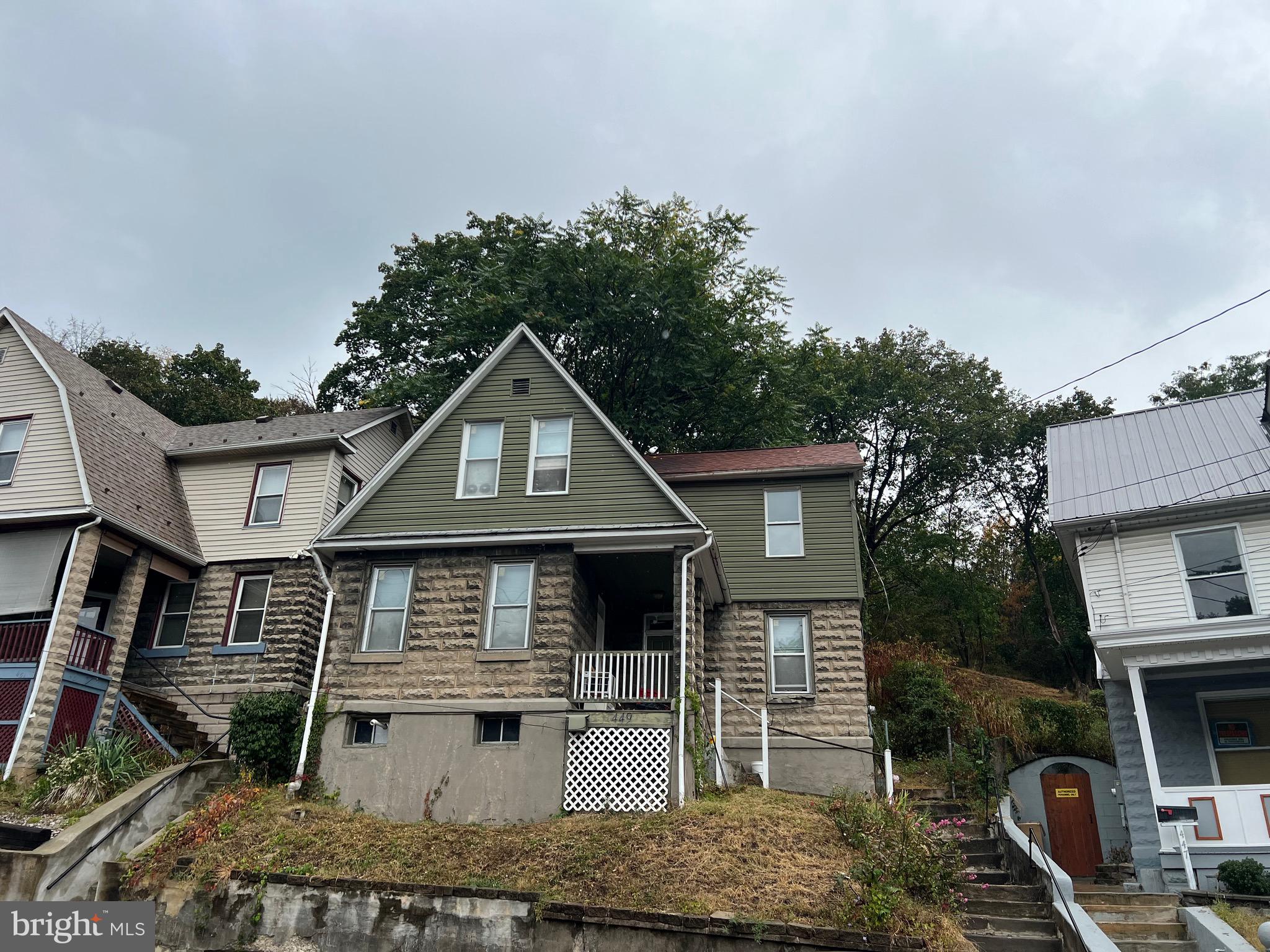 449 Baltimore Avenue Cumberland, MD 21502 - Photo 2 of 22 a front view of a house with garden