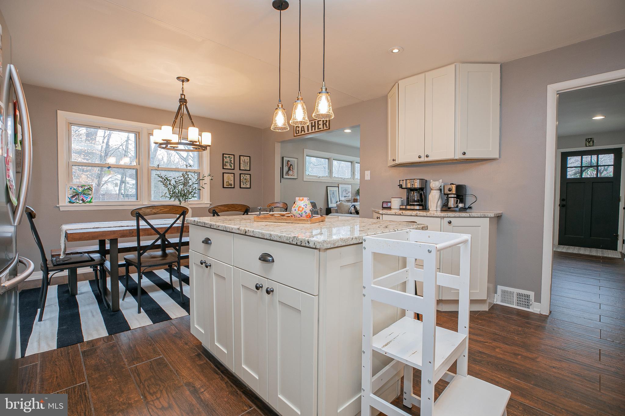 611 Brookwood Road Wayne, PA 19087 - Photo 10 of 41 a kitchen with kitchen island granite countertop a table chairs sink and cabinets