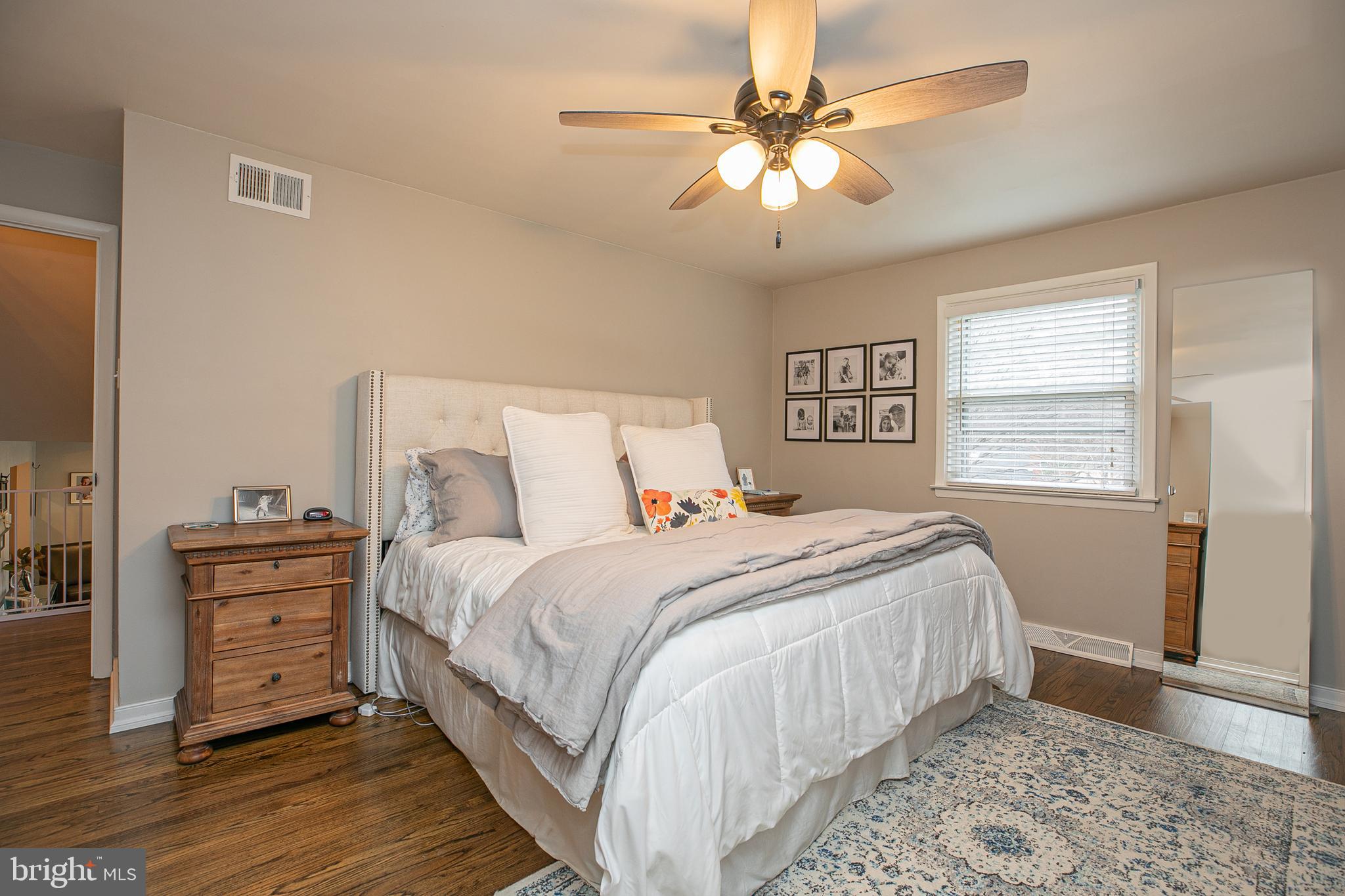 611 Brookwood Road Wayne, PA 19087 - Photo 16 of 41 a bedroom with a large bed and a chandelier