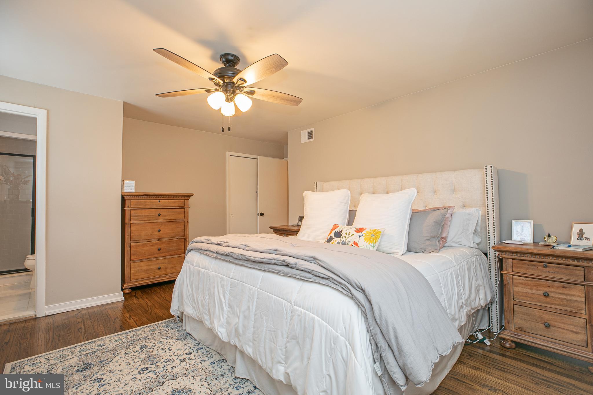 611 Brookwood Road Wayne, PA 19087 - Photo 17 of 41 a bedroom with a bed and a chandelier