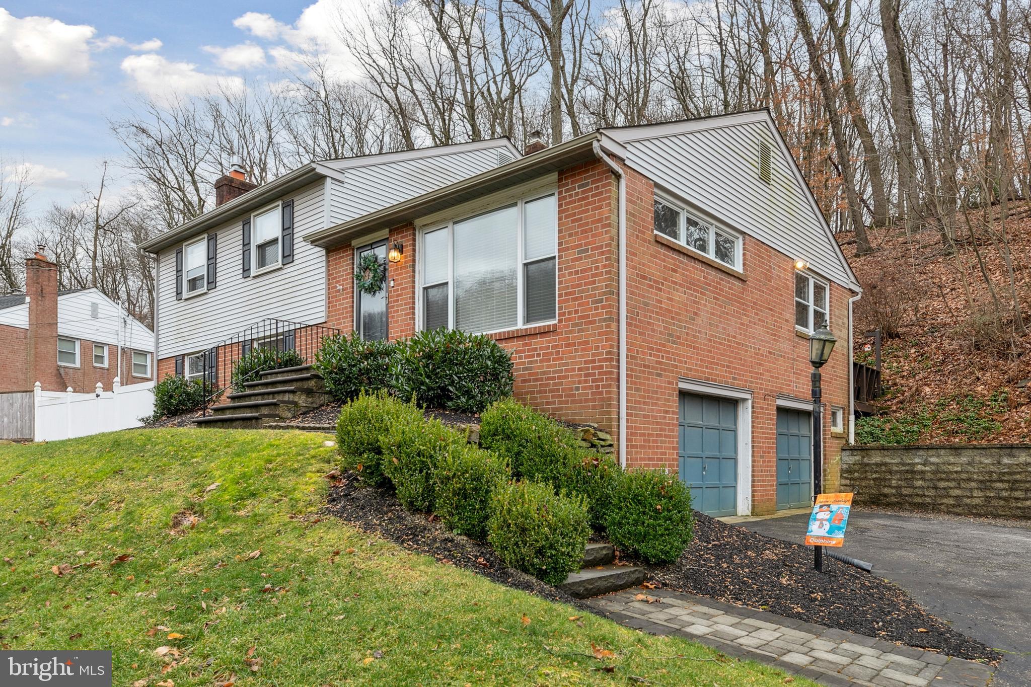611 Brookwood Road Wayne, PA 19087 - Photo 2 of 41 a front view of a house with garden