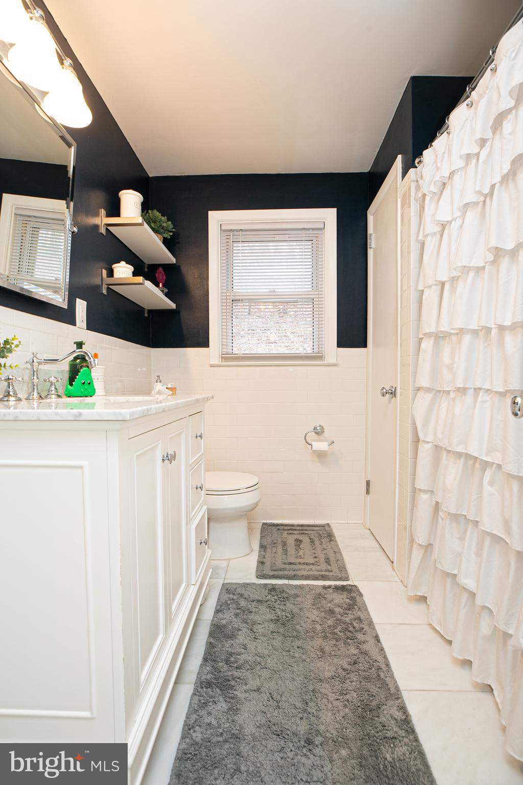611 Brookwood Road Wayne, PA 19087 - Photo 24 of 41 a bathroom with a sink a toilet and mirror