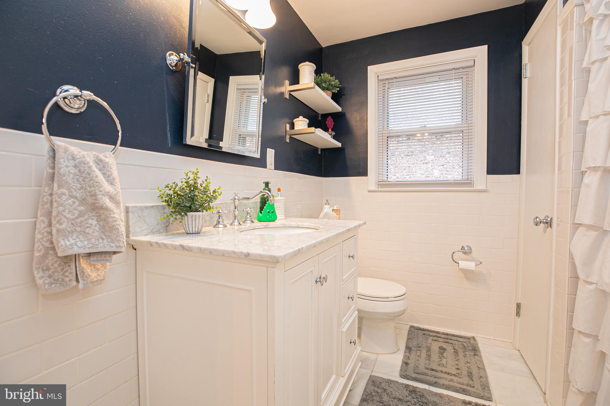 611 Brookwood Road Wayne, PA 19087 - Photo 25 of 41 a bathroom with a toilet sink and mirror