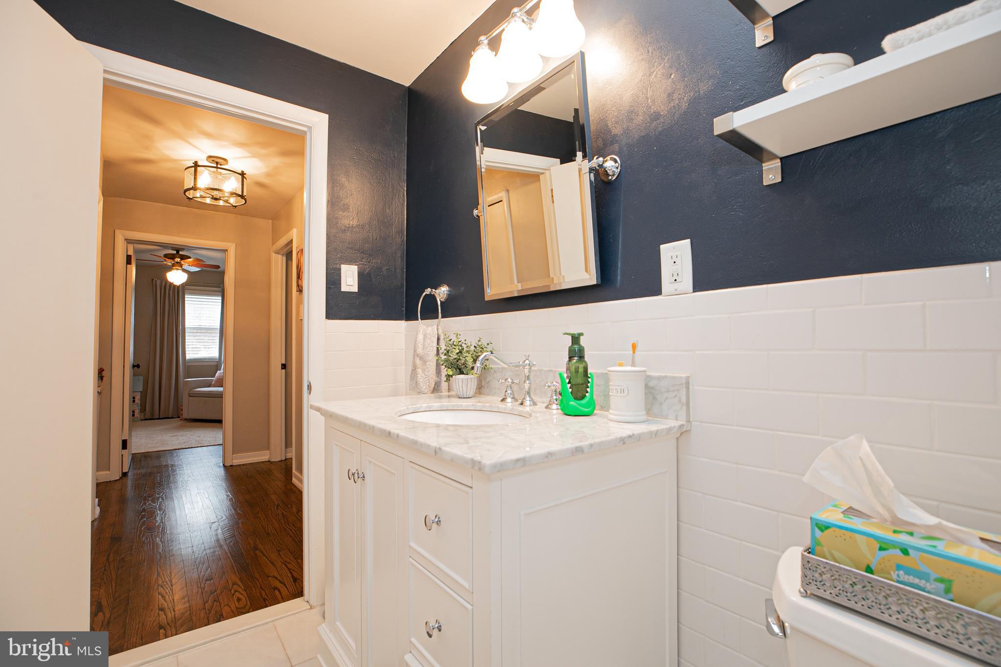 611 Brookwood Road Wayne, PA 19087 - Photo 26 of 41 a bathroom with a sink a vanity and a mirror