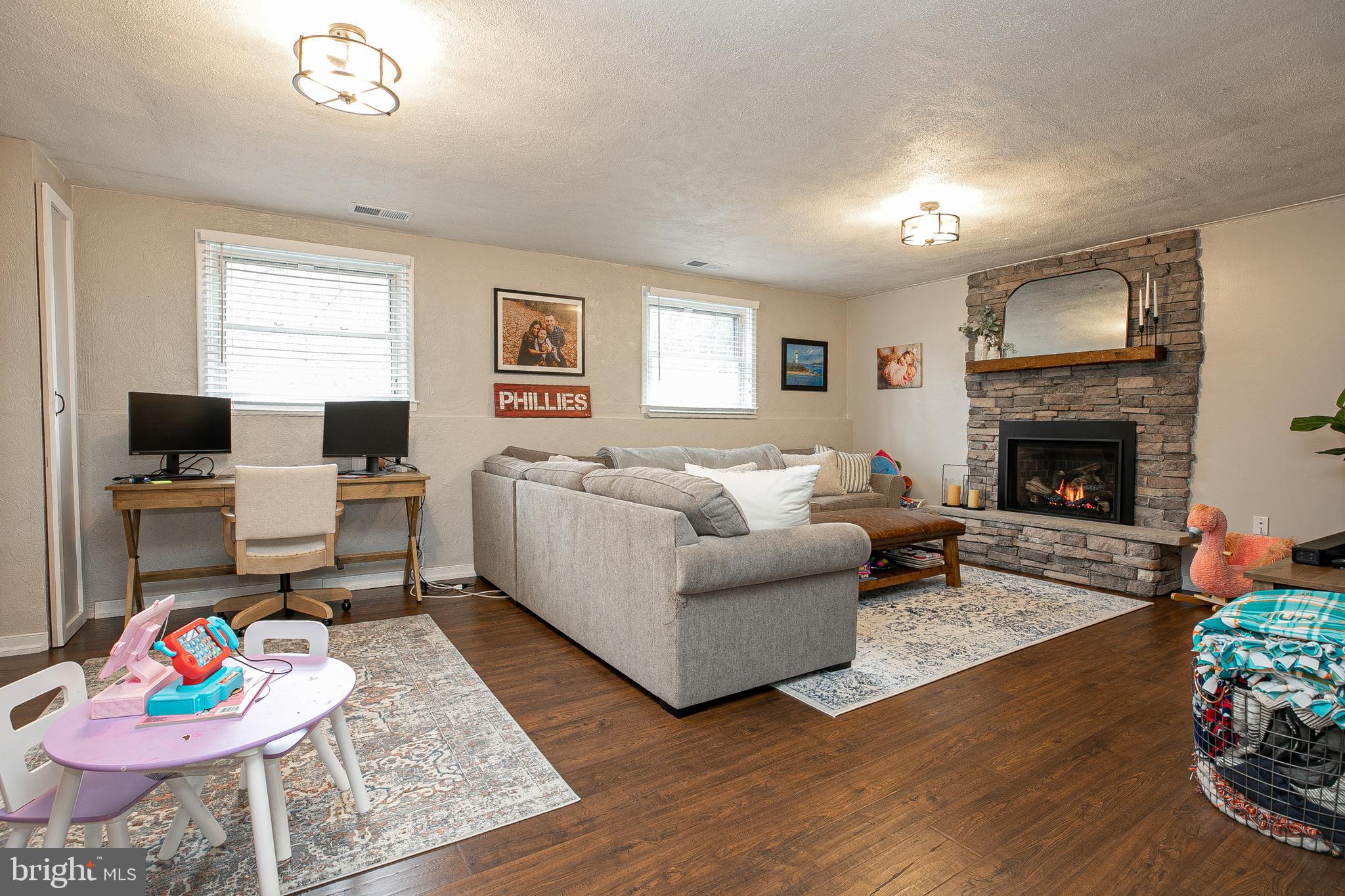 611 Brookwood Road Wayne, PA 19087 - Photo 28 of 41 a living room with furniture fireplace and a window
