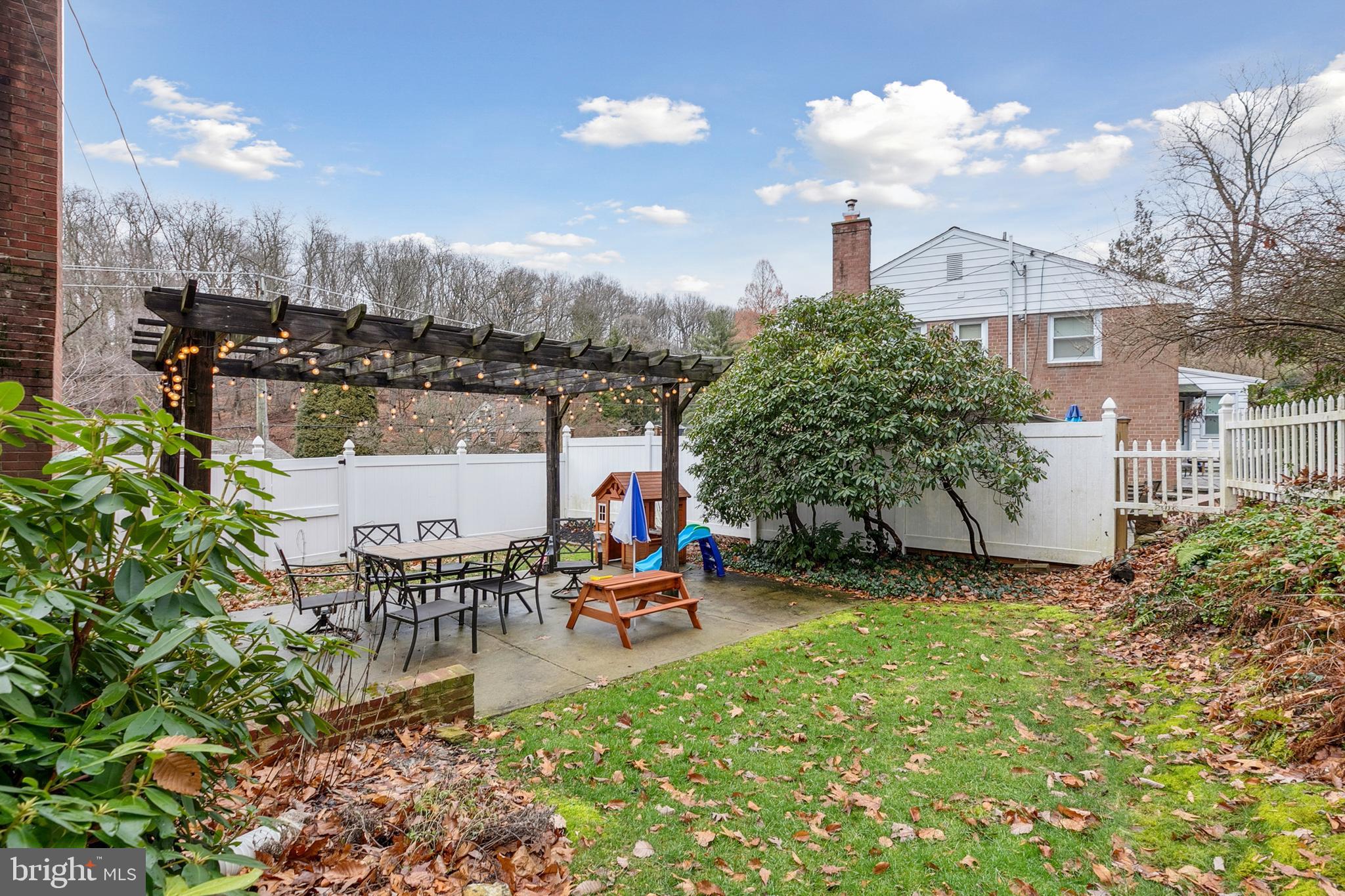 611 Brookwood Road Wayne, PA 19087 - Photo 36 of 41 a man sitting on a bench in front of a building